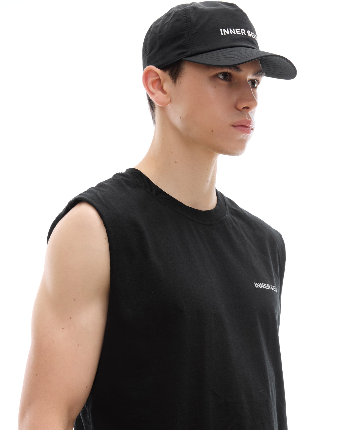 INNER SELF Daily Cap in black — three-quarter view on male model