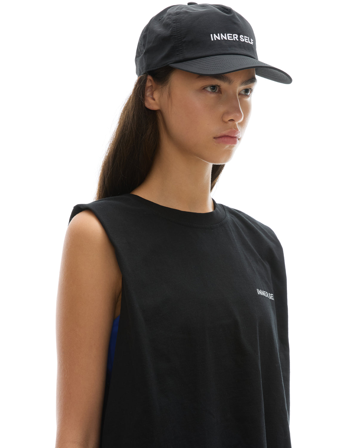 INNER SELF Daily Cap in black — three-quarter view on female model
