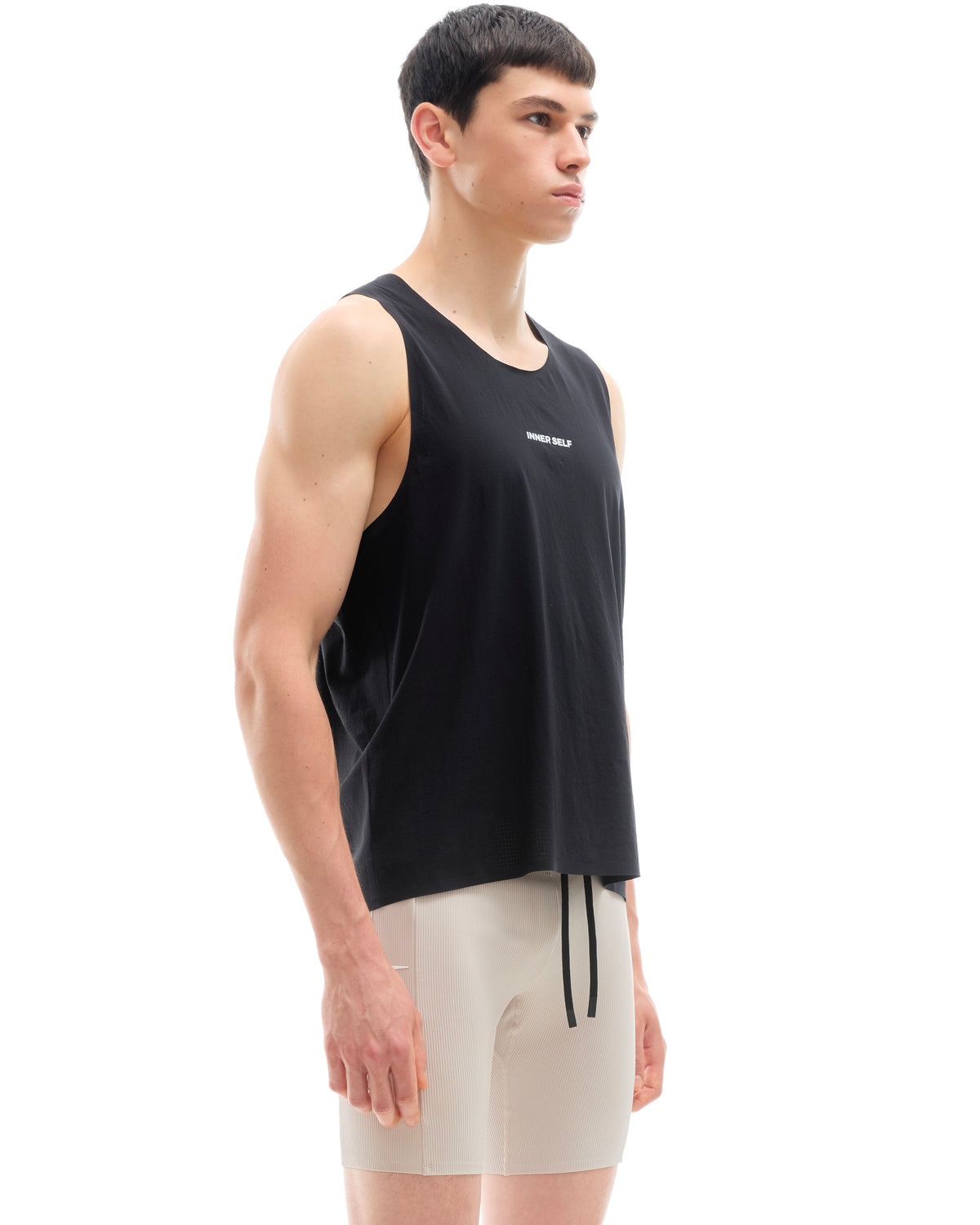 INNER SELF Performance Singlet in black — three-quarter view on male model