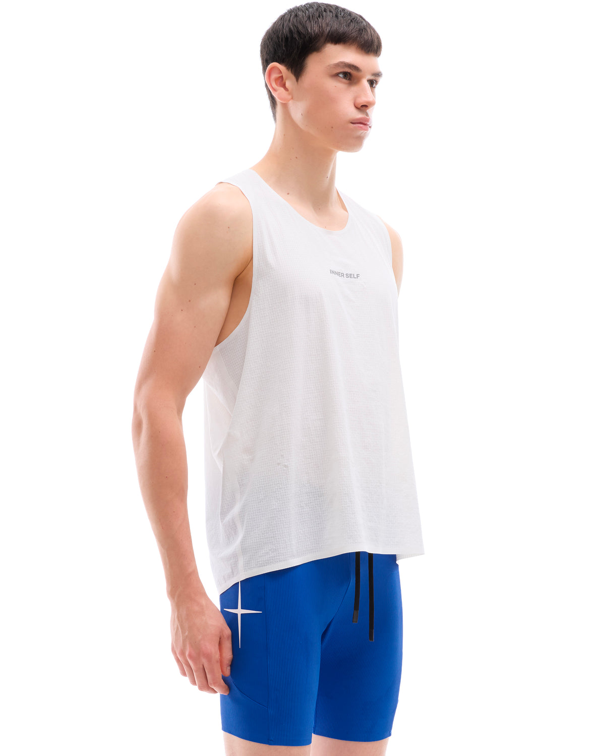 INNER SELF Performance Singlet in white — three-quarter view on male model