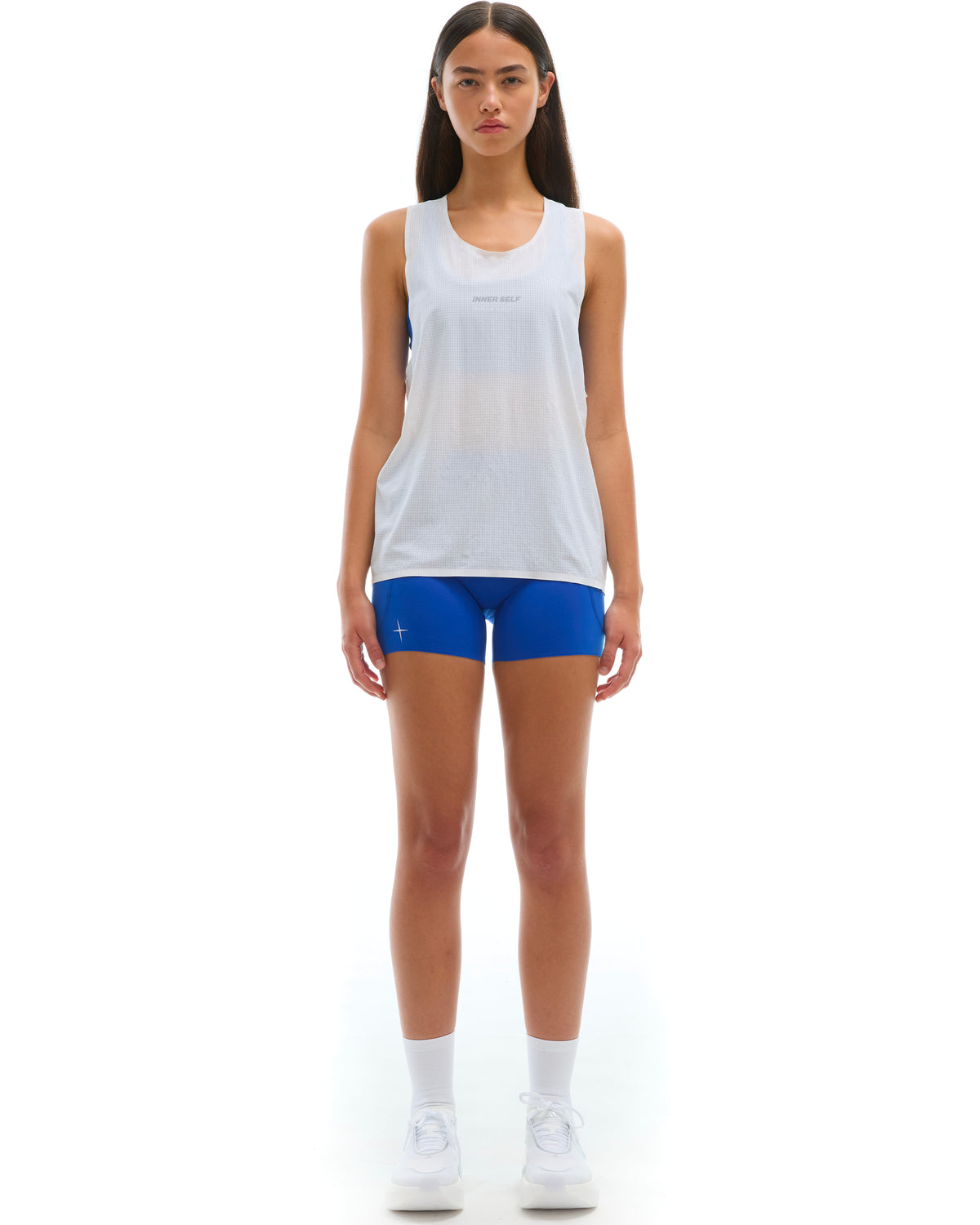 INNER SELF Performance Singlet in white — full-length view on female model