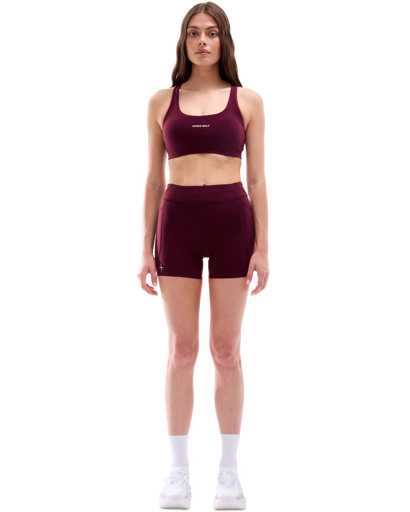 INNER SELF Women's 4'' Half Tights W/ Pockets in red — full-length view on female model